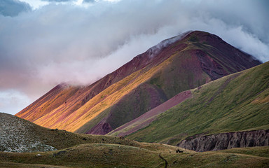 Scenic landscape of mountainы. Beautiful nature. Fog creeps over the mountain top.