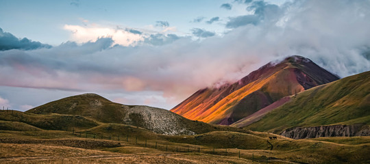 Scenic landscape of mountainы. Beautiful nature. Fog creeps over the mountain top.