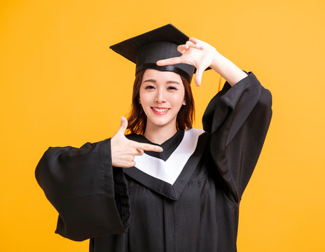 happy young woman in graduation gowns  with looking gesture