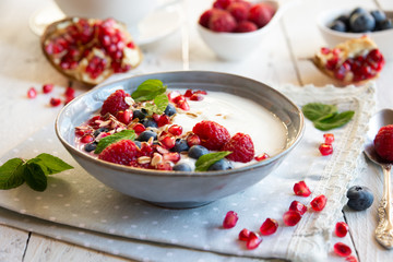 Yogurt with fresh fruit and cereals in a bowl, healthy breakfast
