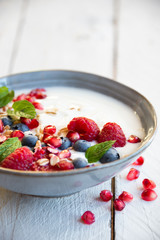 Yogurt with fresh fruit and cereals in a bowl, healthy breakfast