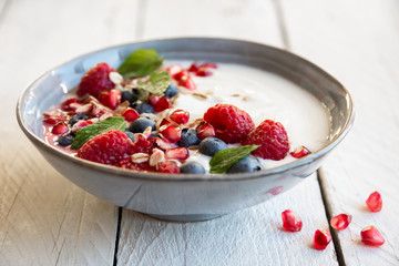 Yogurt with fresh fruit and cereals in a bowl, healthy breakfast