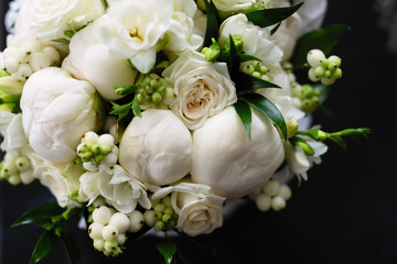 a bouquet of white peonies for the bride, a wedding bouquet close-up, fresh white and green flowers in a bouquet