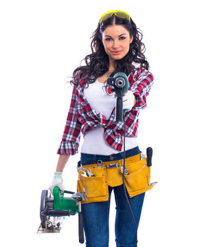 Sexy brunette woman mechanic with circular saw and perforator