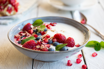 Yogurt with fresh fruit and cereals in a bowl, healthy breakfast