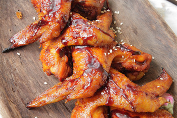 
fried chicken wings in soy sauce with spices and herbs. Fast food, grilled chicken wings. Food delivery.