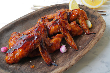 
fried chicken wings in soy sauce with spices and herbs. Fast food, grilled chicken wings. Food delivery.