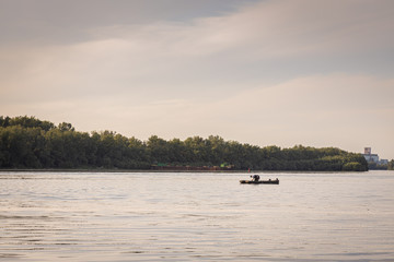 Fototapeta na wymiar Fishing boat on the river on a sunset