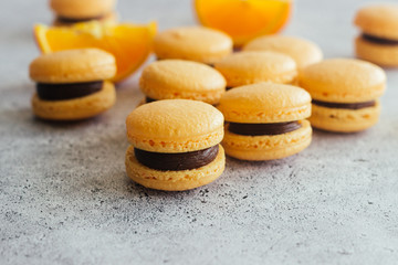 Macaroons. Delicious french desserts. Macaroons with chocolate and orange. Macaroons on the table