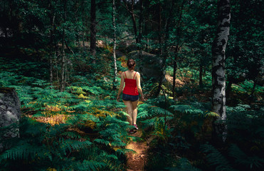 young woman walking in a forest