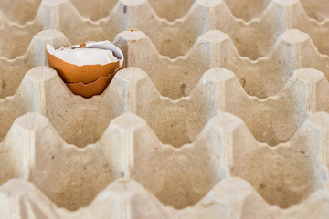 box with broken eggshell brown chicken eggs, background texture pattern