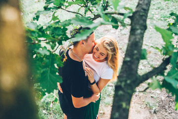 Love story of a couple, engagement in summer on a green field