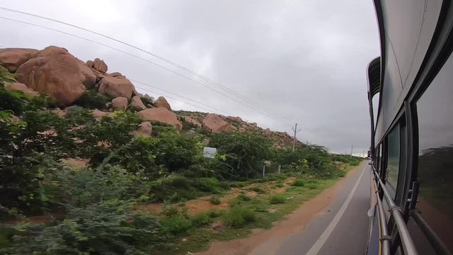 View of big Rock and Green Mountain has been recorded from the running bus. Adoni india.