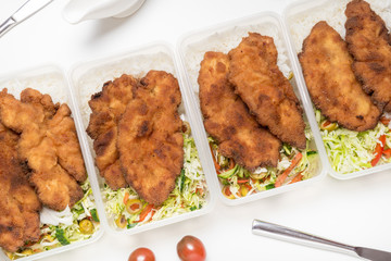 Set of lunch boxes with rice, salad and fried chicken