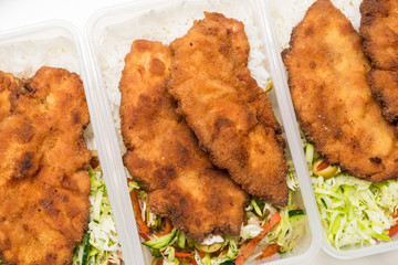 Set of lunch boxes with rice, salad and fried chicken