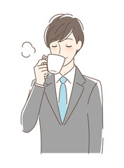 マグカップのコーヒーを飲む男性