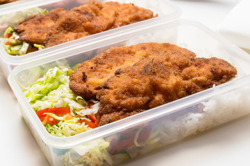 Set of lunch boxes with rice, salad and fried chicken