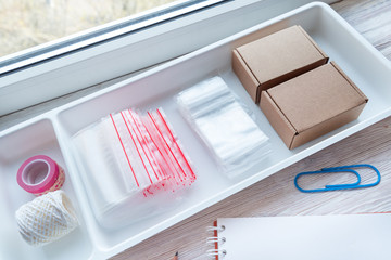 Lot of plastic zip locks on wooden office desk, small online business concept © mdbildes