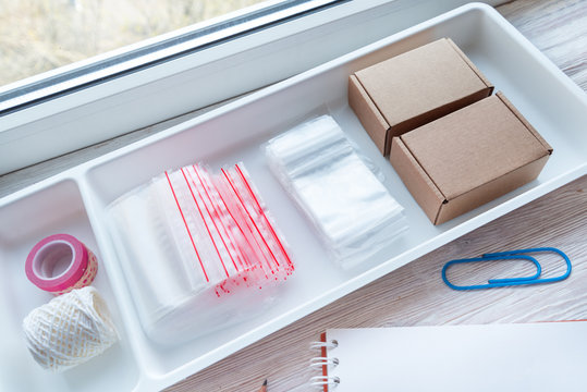 Lot of plastic zip locks on wooden office desk, small online business concept