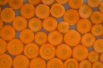 Fresh sliced carrots background texture