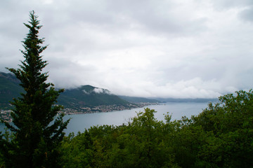 Fototapeta na wymiar Storm clouds cover the mountains and the sea of the Bay of Kotor