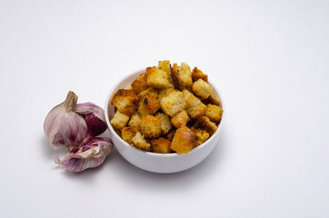 Tasty crackers in a white cup on a white background