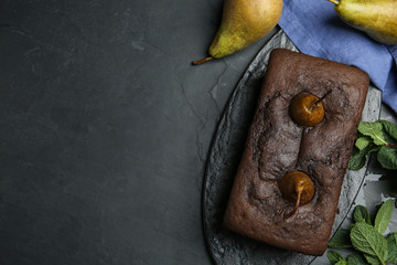 Flat lay composition with tasty pear bread on black table, space for text. Homemade cake