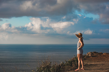 Woman enjoying nice tropical summertime days on the island with sunset / sunrise view.
