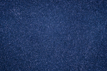 Abstract grain background, dark blue granular texture. Grunge wall shiny surface. Pantone color trend.