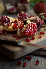Fresh organic pomegranate fruit with leaves on dark background