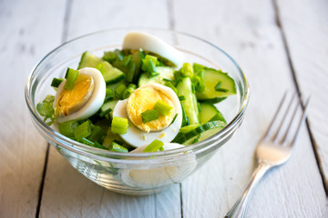 Healthy green salad with cucumbers, eggs and onions