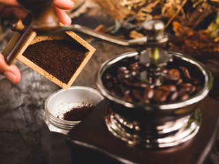Black-brown coffee powder Pouring into a boil After being ground with a coffee grinder With the...