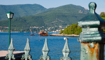 View over the fence at sunken ship near the Rose Village, peninsula of Lustica, Kotor Bay,...