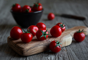 Fresh ripe organic cherry tomatoes on dark background