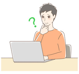 パソコンを操作して悩む男性