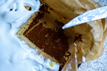 cut homemade fresh apple pie covered with white icing in baking tray with baking paper in it