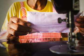 A white mask on the hand of a person