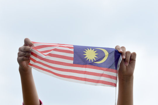 Cropped Hands Holding Malaysian Flag Clear Sky