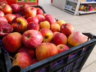 Red apples in drawer sold in food supermarket 's fruit and vegetable department