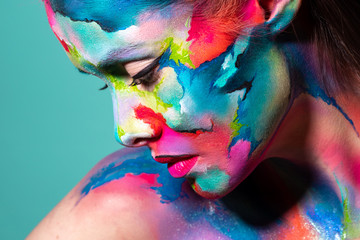 Fashion and creative makeup, young beautiful woman abstract face art,