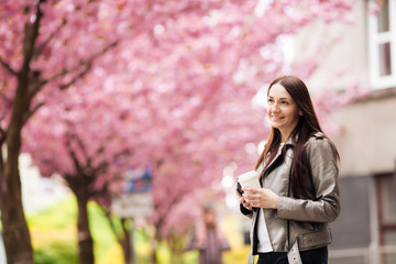 Beautiful European girl near a Japanese tree