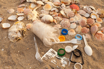 A lot of different plastic waste: disposable plastic cups,plastic bags, disposable spoons, forks,...