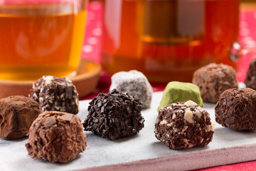 Variety chocolate truffles and earl grey tea.