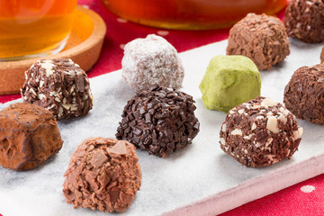 Variety chocolate truffles and earl grey tea.