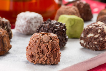 Variety chocolate truffles and earl grey tea.