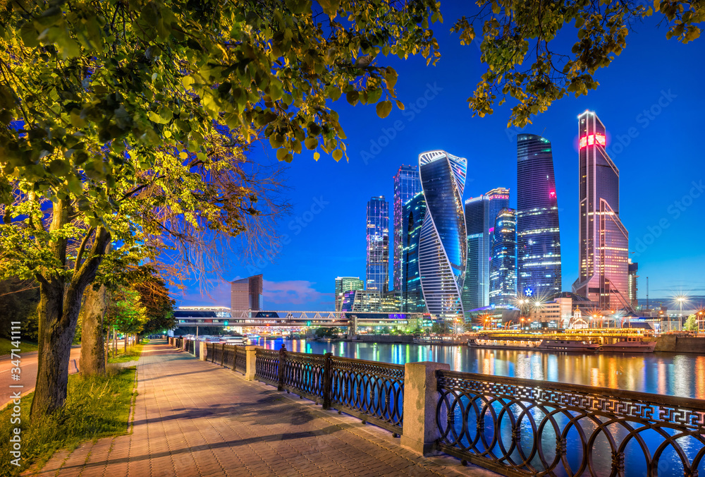 Wall mural Ночной Сити Moscow City skyscrapers in a frame of green trees