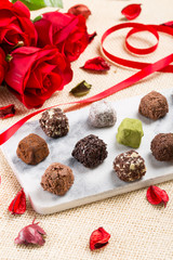 Variety chocolate truffles and rose
