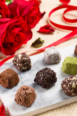 Variety chocolate truffles and rose