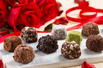 Variety chocolate truffles and rose