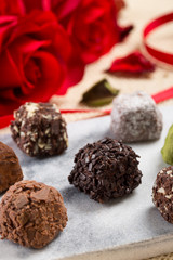 Variety chocolate truffles and rose